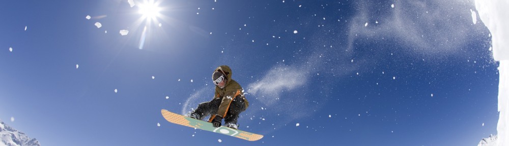 Young man snowboarding