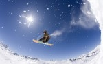 Young man snowboarding