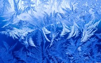 Ice crystals form on a window during sub zero temperatures